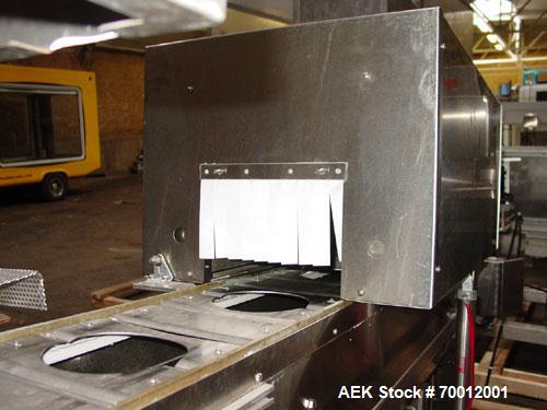 Used Axon EZ300 Stainless Steel Neck Bander With Stainless Steel Tunnel. Capable of speeds up to 70 containers per minute. Can handle product container widths from 2-3/8" to 7-3/8" and sleeve lay fla...