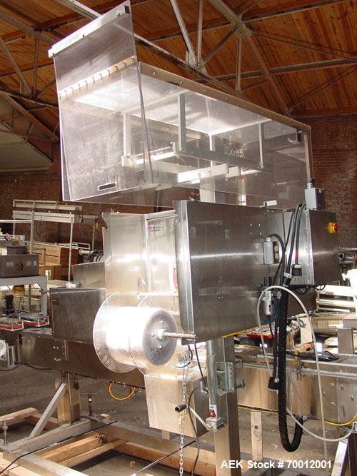 Used Axon EZ300 Stainless Steel Neck Bander With Stainless Steel Tunnel. Capable of speeds up to 70 containers per minute. Can handle product container widths from 2-3/8" to 7-3/8" and sleeve lay fla...