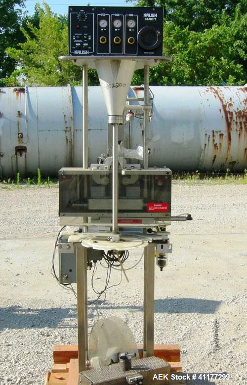 Used Kalsih Bandit Neck Bander, model 5400. Manually adjustable size range, and height. Driven by a 1/6hp, 1/60/120 volt motor. Mounted on a stainless steel frame. Built 1993