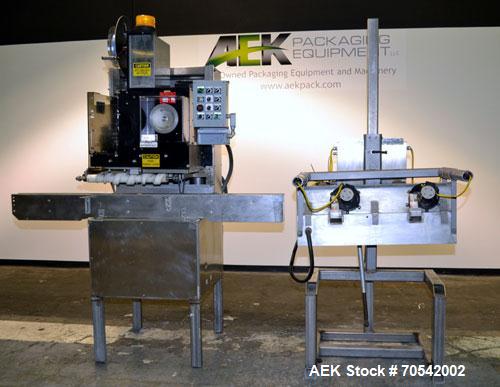 Used PDC Model 75-M Tamper Evident Neck Bander. Capable of speeds up to 300 bottles per minute. Band size range: (Diameter) 3/8" to 3", (Height) 3/4" to 2". Band cut off: Unregistered. Has wormscrew ...