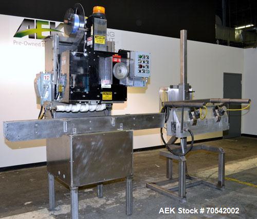 Used PDC Model 75-M Tamper Evident Neck Bander. Capable of speeds up to 300 bottles per minute. Band size range: (Diameter) 3/8" to 3", (Height) 3/4" to 2". Band cut off: Unregistered. Has wormscrew ...