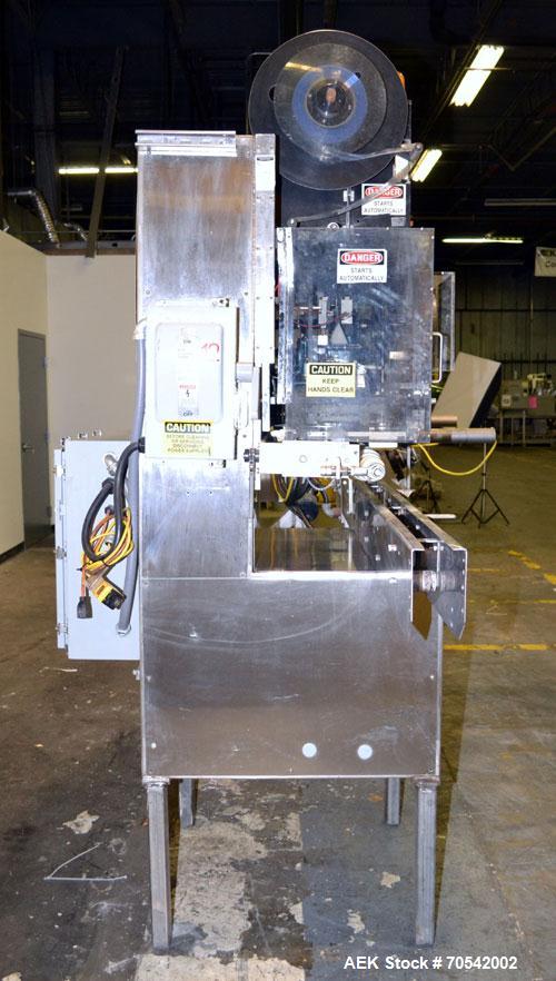 Used PDC Model 75-M Tamper Evident Neck Bander. Capable of speeds up to 300 bottles per minute. Band size range: (Diameter) 3/8" to 3", (Height) 3/4" to 2". Band cut off: Unregistered. Has wormscrew ...
