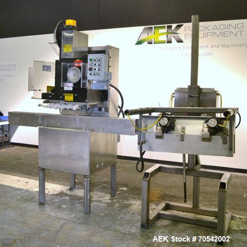 Used PDC Model 75-M Tamper Evident Neck Bander. Capable of speeds up to 300 bottles per minute. Band size range: (Diameter) 3/8" to 3", (Height) 3/4" to 2". Band cut off: Unregistered. Has wormscrew ...