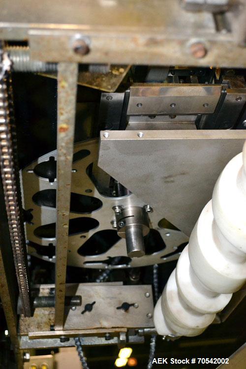 Used PDC Model 75-M Tamper Evident Neck Bander. Capable of speeds up to 300 bottles per minute. Band size range: (Diameter) 3/8" to 3", (Height) 3/4" to 2". Band cut off: Unregistered. Has wormscrew ...