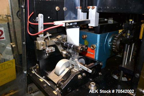Used PDC Model 75-M Tamper Evident Neck Bander. Capable of speeds up to 300 bottles per minute. Band size range: (Diameter) 3/8" to 3", (Height) 3/4" to 2". Band cut off: Unregistered. Has wormscrew ...