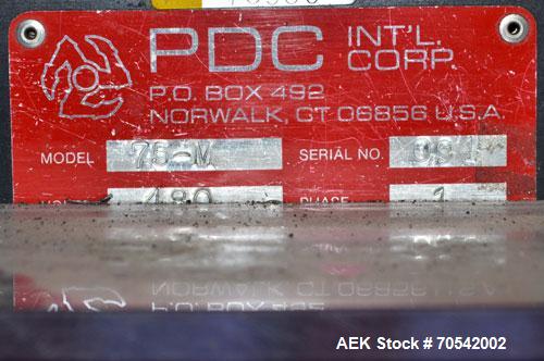 Used PDC Model 75-M Tamper Evident Neck Bander. Capable of speeds up to 300 bottles per minute. Band size range: (Diameter) 3/8" to 3", (Height) 3/4" to 2". Band cut off: Unregistered. Has wormscrew ...