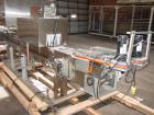 Used Axon EZ300 Stainless Steel Neck Bander With Stainless Steel Tunnel. Capable of speeds up to 70 containers per minute. Can handle product container widths from 2-3/8