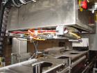 Used Axon EZ300 Stainless Steel Neck Bander With Stainless Steel Tunnel. Capable of speeds up to 70 containers per minute. Can handle product container widths from 2-3/8