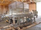 Used Axon EZ-2-400 Twin Head Stainless Steel Neck Bander With Twin Stainless Steel Heat Tunnels. Capable of speeds up to 90 CPM. Container size range widths from 3-11/16