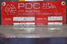 Used PDC Model 75-M Tamper Evident Neck Bander. Capable of speeds up to 300 bottles per minute. Band size range: (Diameter) 3/8