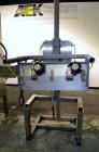Used PDC Model 75-M Tamper Evident Neck Bander. Capable of speeds up to 300 bottles per minute. Band size range: (Diameter) 3/8