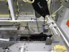 Used Adco Model 15DBC105-EC Automatic Horizontal Cartoner. Capable of speeds from 50 to 125 cartons per minute. Has two head rotary carton feed with 4' long magazine. Machine is set on 12