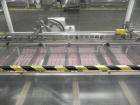 Used Adco Model 15DBC105-EC Automatic Horizontal Cartoner. Capable of speeds from 50 to 125 cartons per minute. Has two head rotary carton feed with 4' long magazine. Machine is set on 12