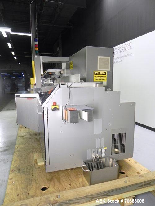 Used Uhlmann Model C2205 Automatic Bottle Cartoner. Capable of speeds up to 250 cartons per minute. Is a continuous motion cartoner. Has a 5" pitch for a Maximum carton size range: (Length) 150mm (6"...