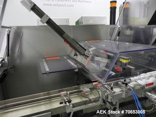 Used Uhlmann Model C2205 Automatic Bottle Cartoner. Capable of speeds up to 250 cartons per minute. Is a continuous motion cartoner. Has a 5" pitch for a Maximum carton size range: (Length) 150mm (6"...