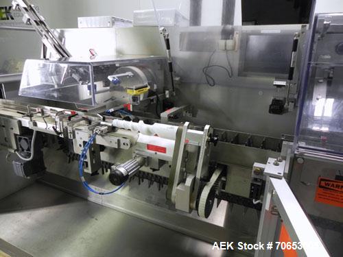 Used Uhlmann Model C2205 Automatic Bottle Cartoner. Capable of speeds up to 250 cartons per minute. Is a continuous motion cartoner. Has a 5" pitch for a Maximum carton size range: (Length) 150mm (6"...