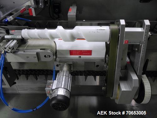Used Uhlmann Model C2205 Automatic Bottle Cartoner. Capable of speeds up to 250 cartons per minute. Is a continuous motion cartoner. Has a 5" pitch for a Maximum carton size range: (Length) 150mm (6"...