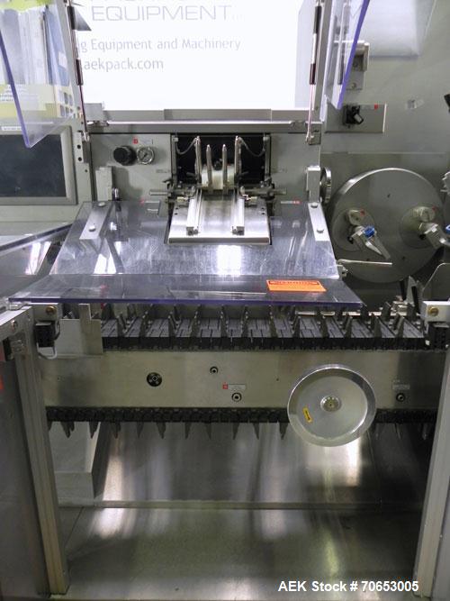 Used Uhlmann Model C2205 Automatic Bottle Cartoner. Capable of speeds up to 250 cartons per minute. Is a continuous motion cartoner. Has a 5" pitch for a Maximum carton size range: (Length) 150mm (6"...