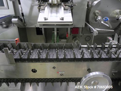 Used Uhlmann Model C2205 Automatic Bottle Cartoner. Capable of speeds up to 250 cartons per minute. Is a continuous motion cartoner. Has a 5" pitch for a Maximum carton size range: (Length) 150mm (6"...