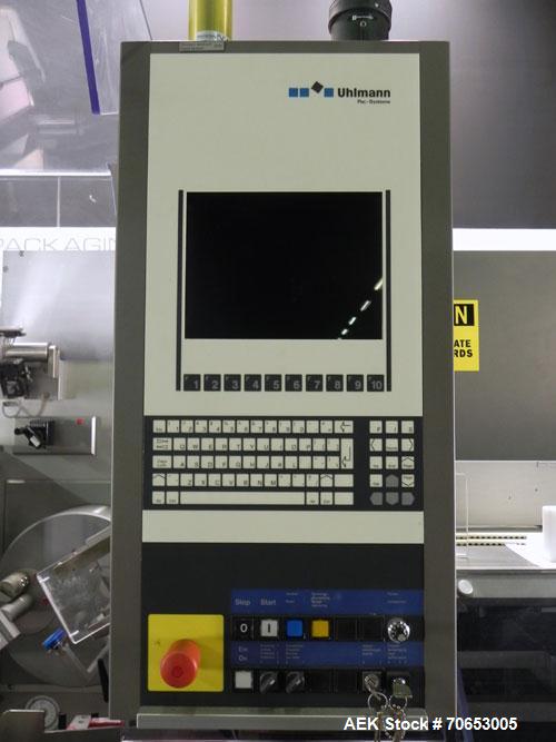 Used Uhlmann Model C2205 Automatic Bottle Cartoner. Capable of speeds up to 250 cartons per minute. Is a continuous motion cartoner. Has a 5" pitch for a Maximum carton size range: (Length) 150mm (6"...