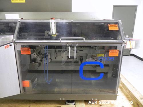 Used Uhlmann Model C2205 Automatic Bottle Cartoner. Capable of speeds up to 250 cartons per minute. Is a continuous motion cartoner. Has a 5" pitch for a Maximum carton size range: (Length) 150mm (6"...