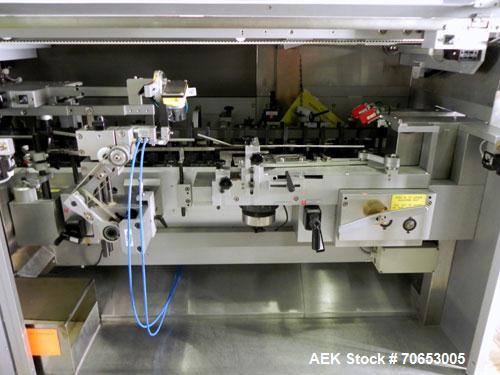 Used Uhlmann Model C2205 Automatic Bottle Cartoner. Capable of speeds up to 250 cartons per minute. Is a continuous motion cartoner. Has a 5" pitch for a Maximum carton size range: (Length) 150mm (6"...