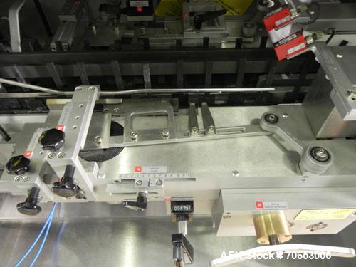 Used Uhlmann Model C2205 Automatic Bottle Cartoner. Capable of speeds up to 250 cartons per minute. Is a continuous motion cartoner. Has a 5" pitch for a Maximum carton size range: (Length) 150mm (6"...