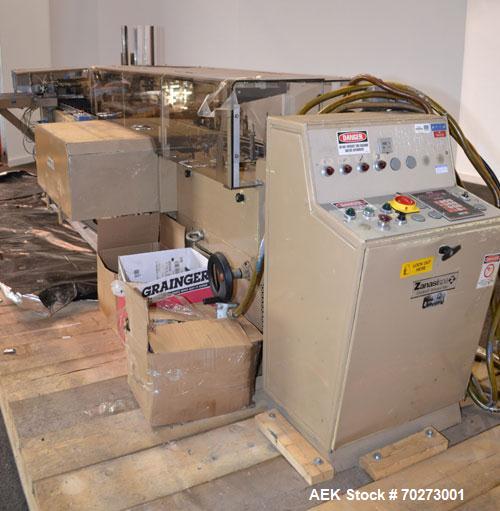 Used Zanasi Automatic Horizontal Continuous Motion Cartoner, Model KA, S/N 54127. This is a standard cartoner which was last running 5th panel tuck cartons, last running tubes and includes infeed sec...