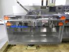 Used Uhlmann Model C2205 Automatic Bottle Cartoner. Capable of speeds up to 250 cartons per minute. Is a continuous motion cartoner. Has a 5