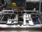 Used Uhlmann Model C2205 Automatic Bottle Cartoner. Capable of speeds up to 250 cartons per minute. Is a continuous motion cartoner. Has a 5