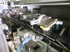 Used Uhlmann Model C2205 Automatic Bottle Cartoner. Capable of speeds up to 250 cartons per minute. Is a continuous motion cartoner. Has a 5