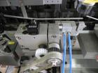 Used Uhlmann Model C2205 Automatic Bottle Cartoner. Capable of speeds up to 250 cartons per minute. Is a continuous motion cartoner. Has a 5