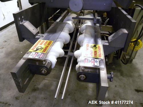 Used Adco Automatic Wraparound Carton Sleever, Model 12WA-125-33. Capable of speeds up to 125 cpm. Fully automatic multipack system for packaging beverage bottles, cans, cups, tubs, trays up to 125 s...