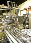 Used Adco Automatic Wraparound Carton Sleever, Model 12WA-125-33. Capable of speeds up to 125 cpm. Fully automatic multipack system for packaging beverage bottles, cans, cups, tubs, trays up to 125 s...