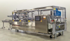 Used Switchback AM-3H Multi-Pack Sleeve Style Cartoner. In-feed for 2 x 2 (inverted top layer) and 2 x 1 cups with 1:2 product divider. Overhead carton load, gluing and sealing of carton overlap seam...