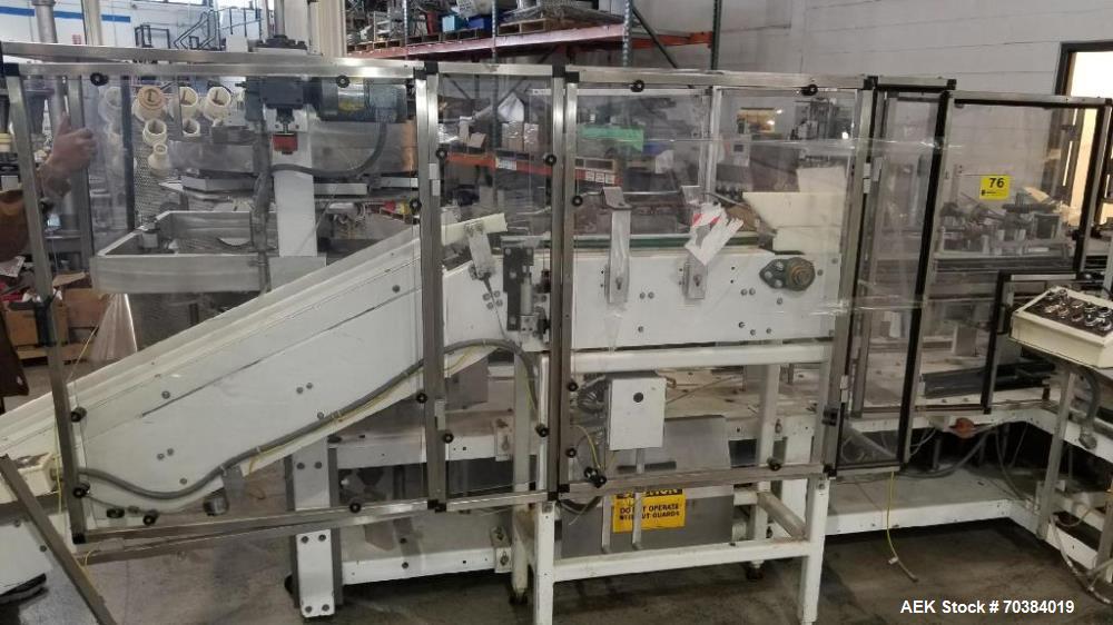 Used- Adco Vertical Cartoner. With 6" centers - set for macaroni and cheese boxes with foil pouch. Rotary carton pick off to...