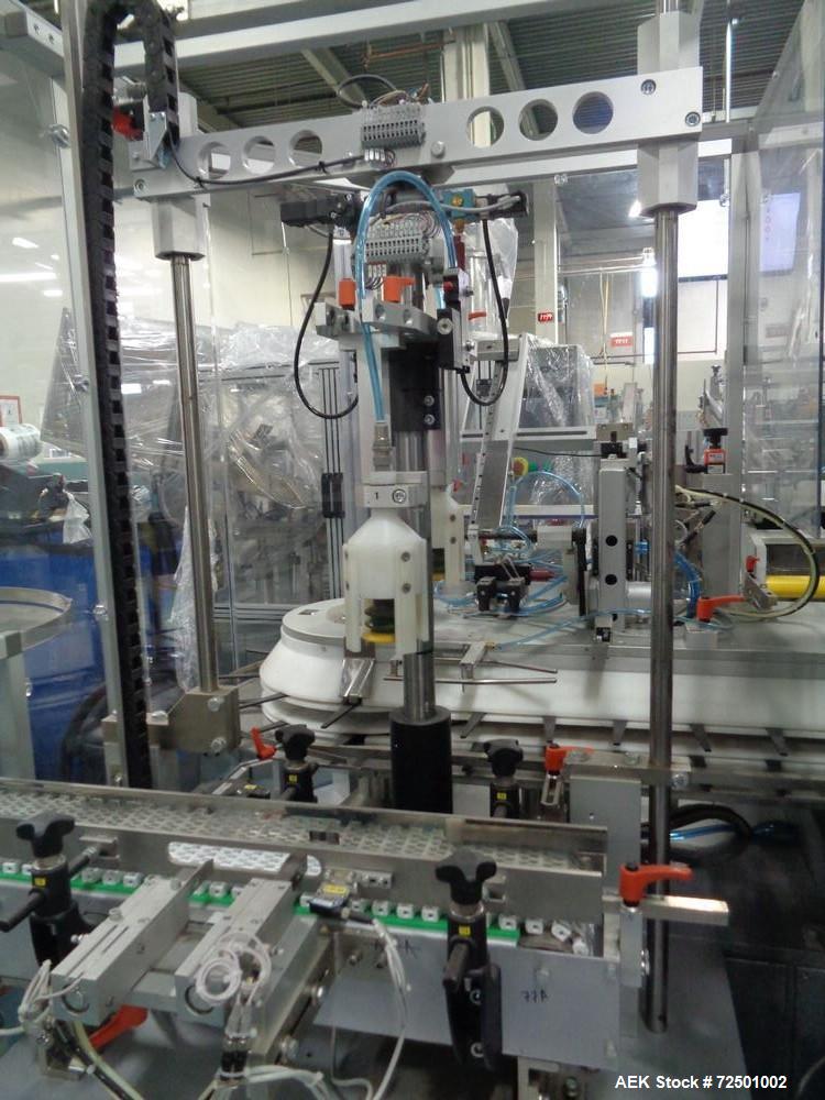 Used-Cariba Model C230 Automatic intermittant motion vertical cartoner with robotic loader for bottles/jars. Capable of spee...