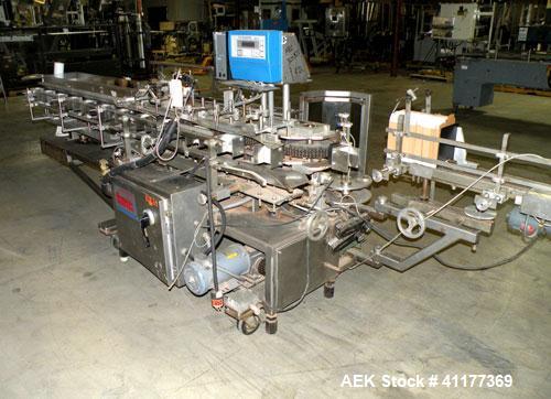 Used Tisma Intermittent Motion Vertical Hot Melt Cartoner, Model TC-50-E. Capable of speeds up to 60 CPM. Has 10" centers, two head rotary carton feeder with 36" long carton magazine and 5' load area...