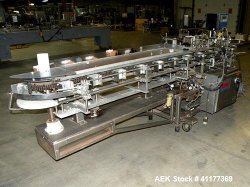 Used Tisma Intermittent Motion Vertical Hot Melt Cartoner, Model TC-50-E. Capable of speeds up to 60 CPM. Has 10" centers, two head rotary carton feeder with 36" long carton magazine and 5' load area...