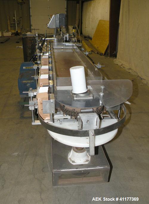 Used Tisma Intermittent Motion Vertical Hot Melt Cartoner, Model TC-50-E. Capable of speeds up to 60 CPM. Has 10" centers, two head rotary carton feeder with 36" long carton magazine and 5' load area...