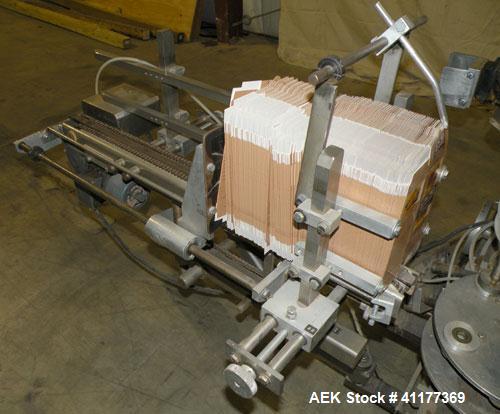 Used Tisma Intermittent Motion Vertical Hot Melt Cartoner, Model TC-50-E. Capable of speeds up to 60 CPM. Has 10" centers, two head rotary carton feeder with 36" long carton magazine and 5' load area...