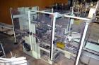 Used Jones Model CMV5 Semi-Automatic Tuck Vertical Cartoner. Machine is capable of speeds up to 120 cartons per minute. Has manual load station of 8' (both sides). Has 5