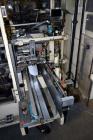 Used Jones Model CMV5 Semi-Automatic Tuck Vertical Cartoner. Machine is capable of speeds up to 120 cartons per minute. Has manual load station of 8' (both sides). Has 5