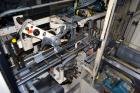Used Jones Model CMV5 Semi-Automatic Tuck Vertical Cartoner. Machine is capable of speeds up to 120 cartons per minute. Has manual load station of 8' (both sides). Has 5