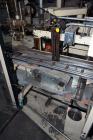Used Jones Model CMV5 Semi-Automatic Tuck Vertical Cartoner. Machine is capable of speeds up to 120 cartons per minute. Has manual load station of 8' (both sides). Has 5