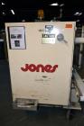Used Jones Model CMV5 Semi-Automatic Tuck Vertical Cartoner. Machine is capable of speeds up to 120 cartons per minute. Has manual load station of 8' (both sides). Has 5