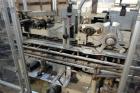 Used Jones Model CMV5 Semi-Automatic Tuck Vertical Cartoner. Machine is capable of speeds up to 120 cartons per minute. Has manual load station of 8' (both sides). Has 5