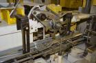 Used Jones Model CMV5 Semi-Automatic Tuck Vertical Cartoner. Machine is capable of speeds up to 120 cartons per minute. Has manual load station of 8' (both sides). Has 5