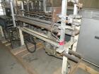 Used Paxall Clybourn Semi Automatic Vertical Hot Melt Cartoner, Model CHL-A. Capable of speeds up to 120 cpm. Has 6' long powered carton magazine with rotary carton feeder. Currently set up on 5