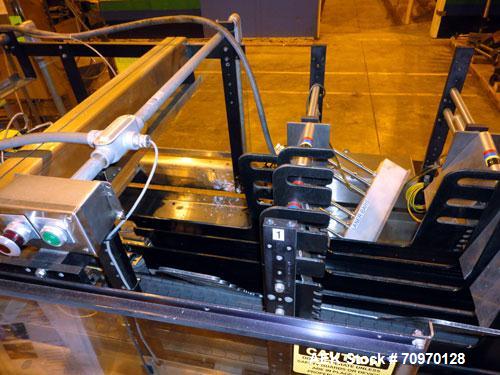 Used Hartness 825-AT automatic stainless steel drop case packer case packer capable of speeds up to 35 cases per minute (depending on product and application). Case size range: (Length) 6" - 24" (Wid...